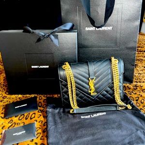 New Yves Saint Laurent Medium Envelope bag in black with gold hardware.